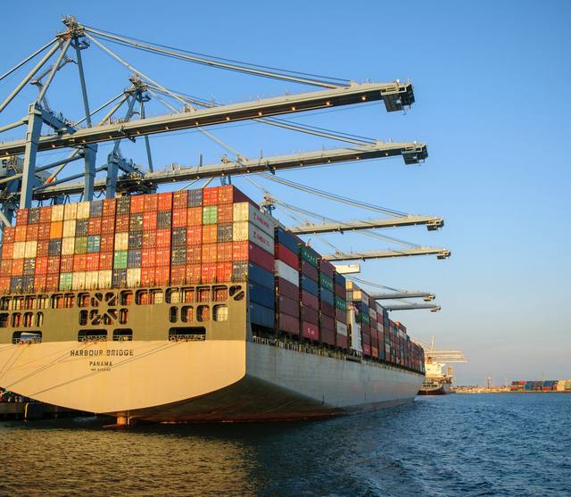A container ship being loaded by port cranes