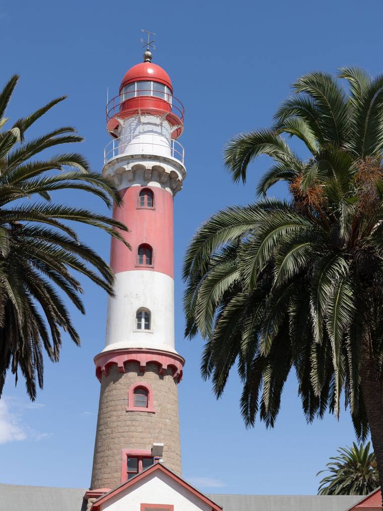 The Swakopmund lighthouse between palm trees